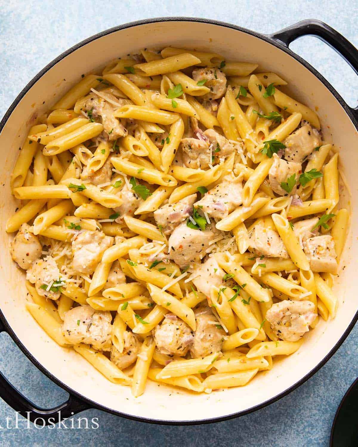 lemon chicken pasta in a large white pan.