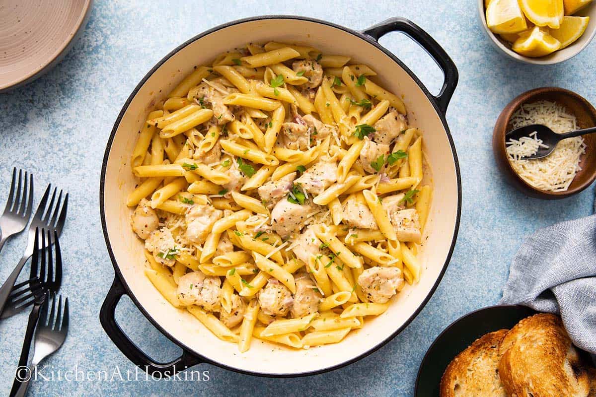 lemon chicken pasta in a large white pan.