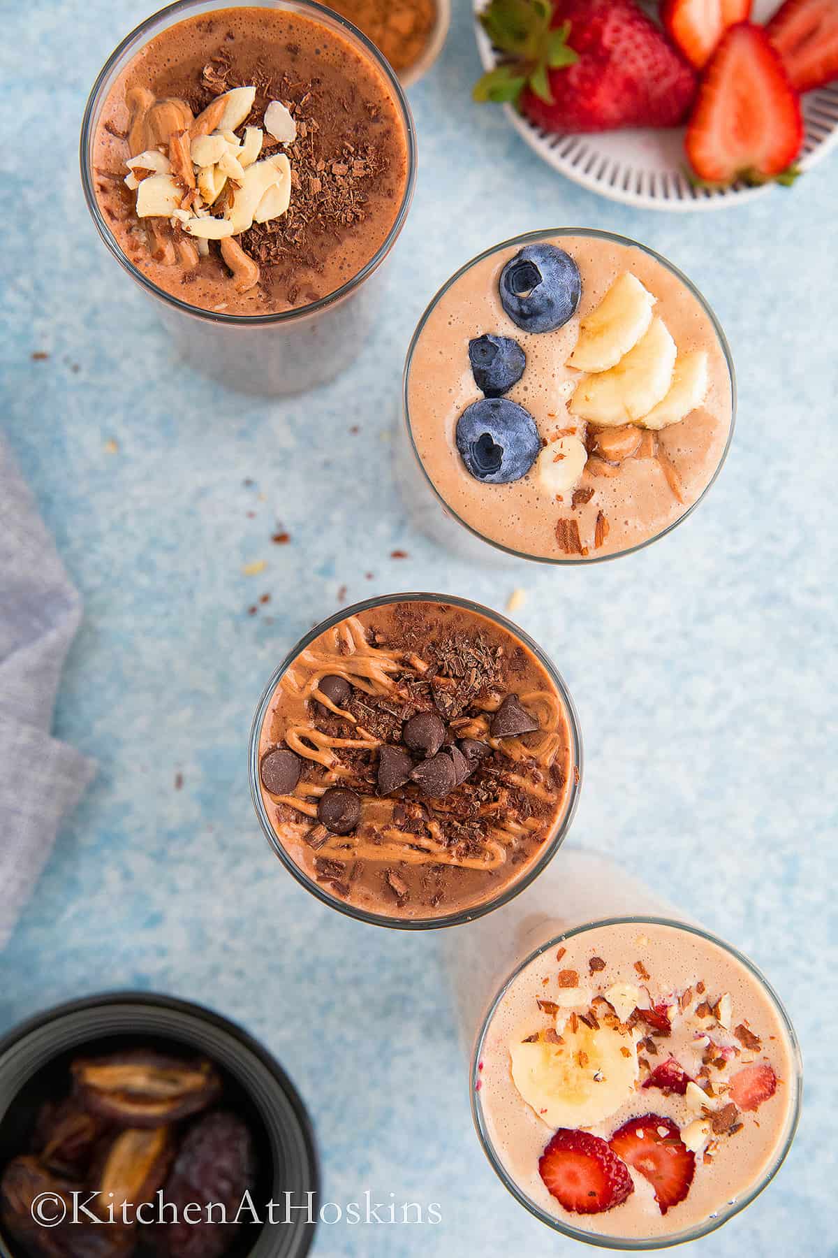 4 glasses filled with peanut butter smoothies.