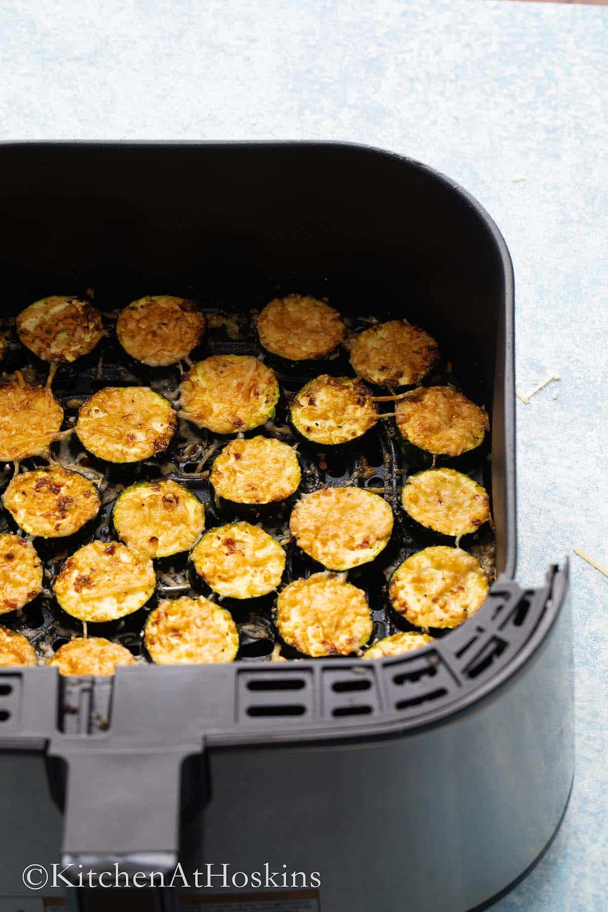 roasted zucchini in air fryer basket.