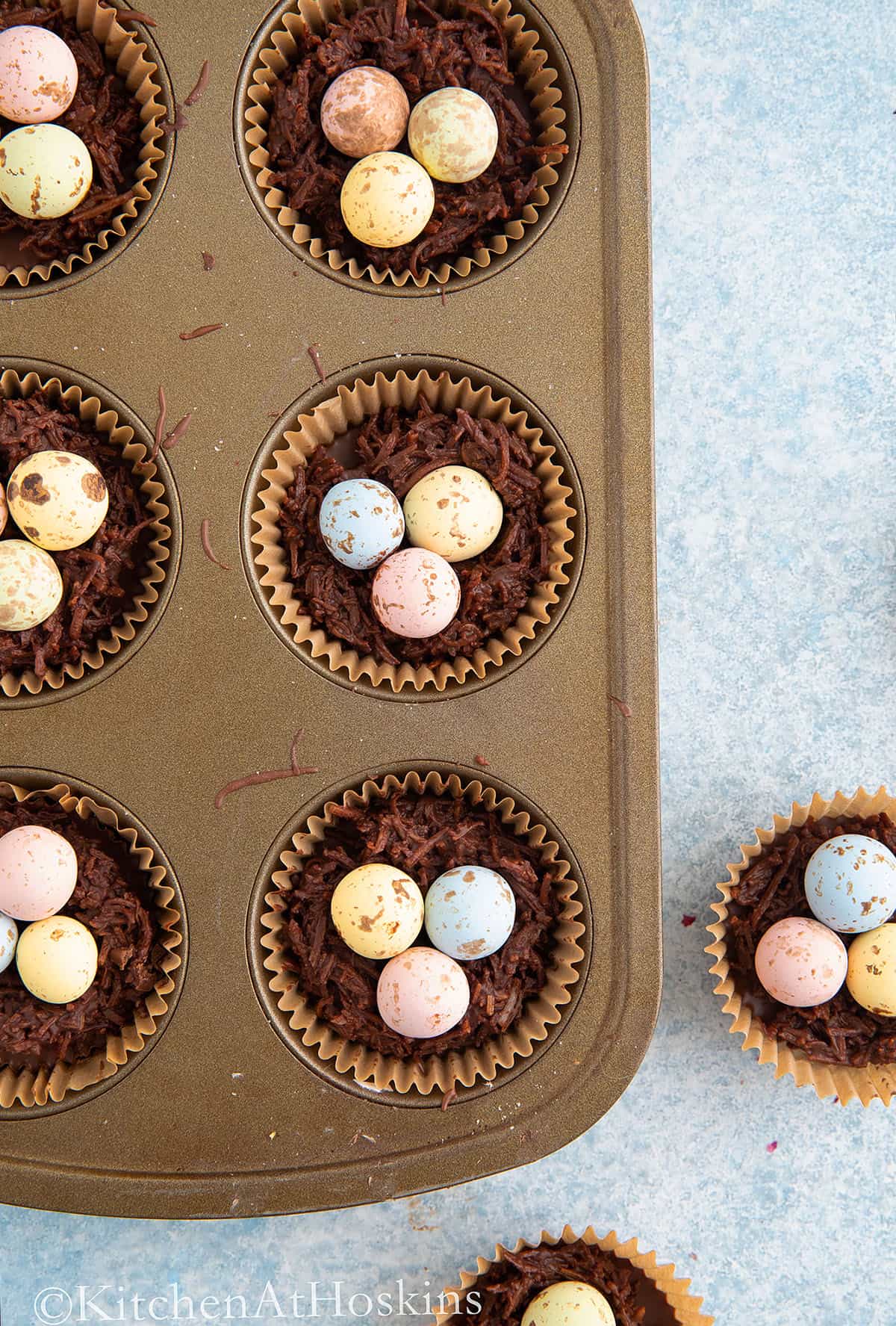 muffin pan with chocolate nests. 