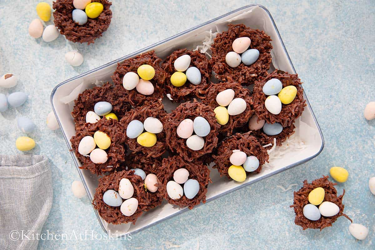 white rectangle tray filled with chocolate nests with 3 candy eggs each.