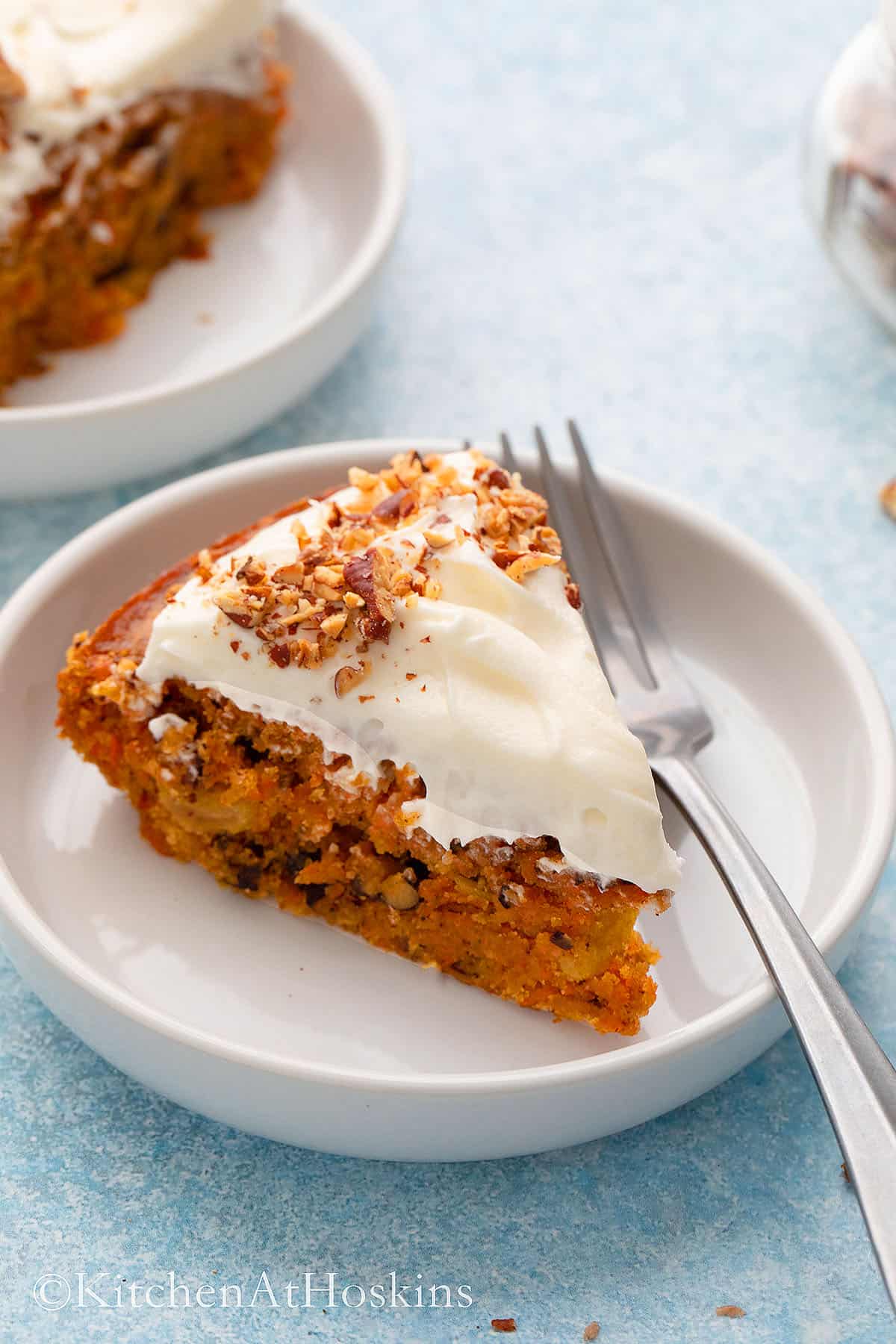 a slice of one layer carrot cake on a white plate with fork. 