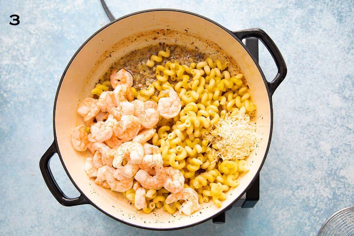 cooked shrimp, pasta,  lemony sauce in a white skillet.