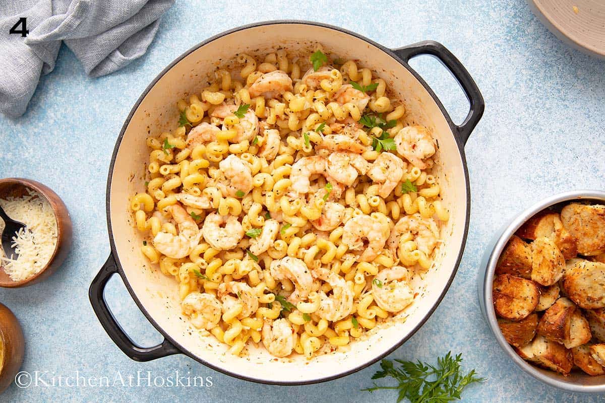 shrimp pasta in a large white skillet.