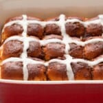 8 hot cross buns in a red dish.