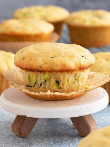 lemon zucchini muffin placed on a mini cake stand.
