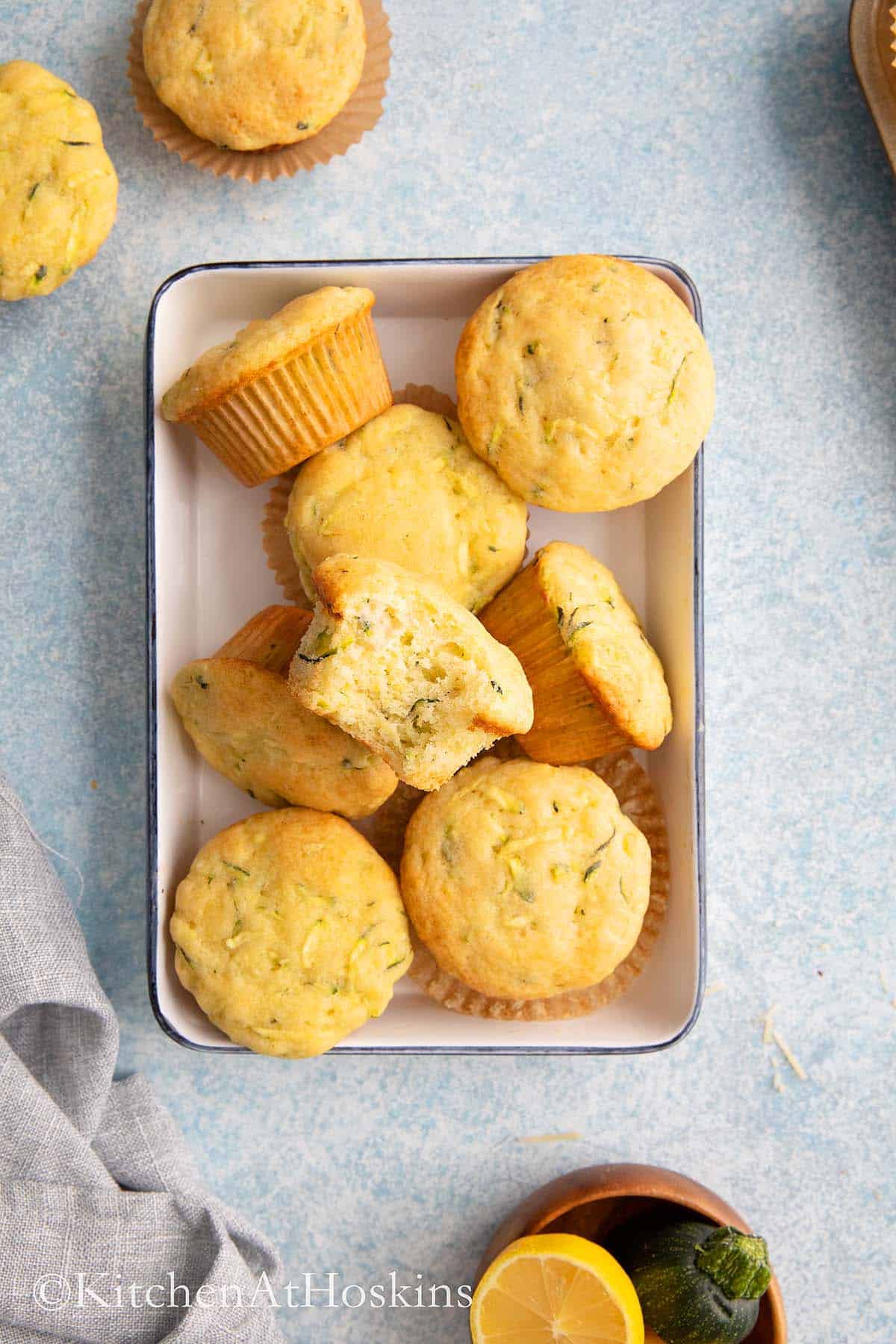 baked lemon zucchini muffins on white tray. 