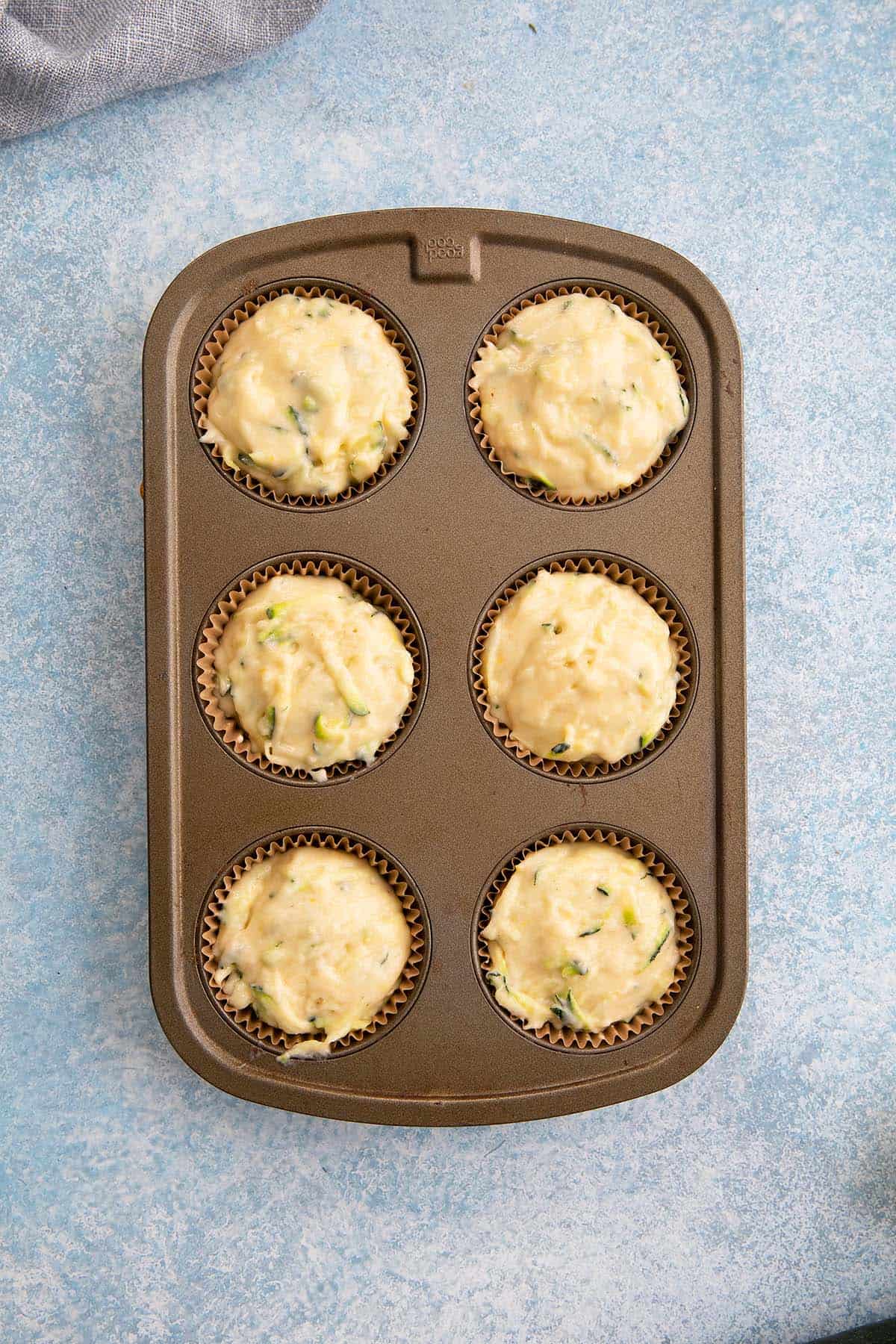 muffin pan with batter ready to go in the oven.