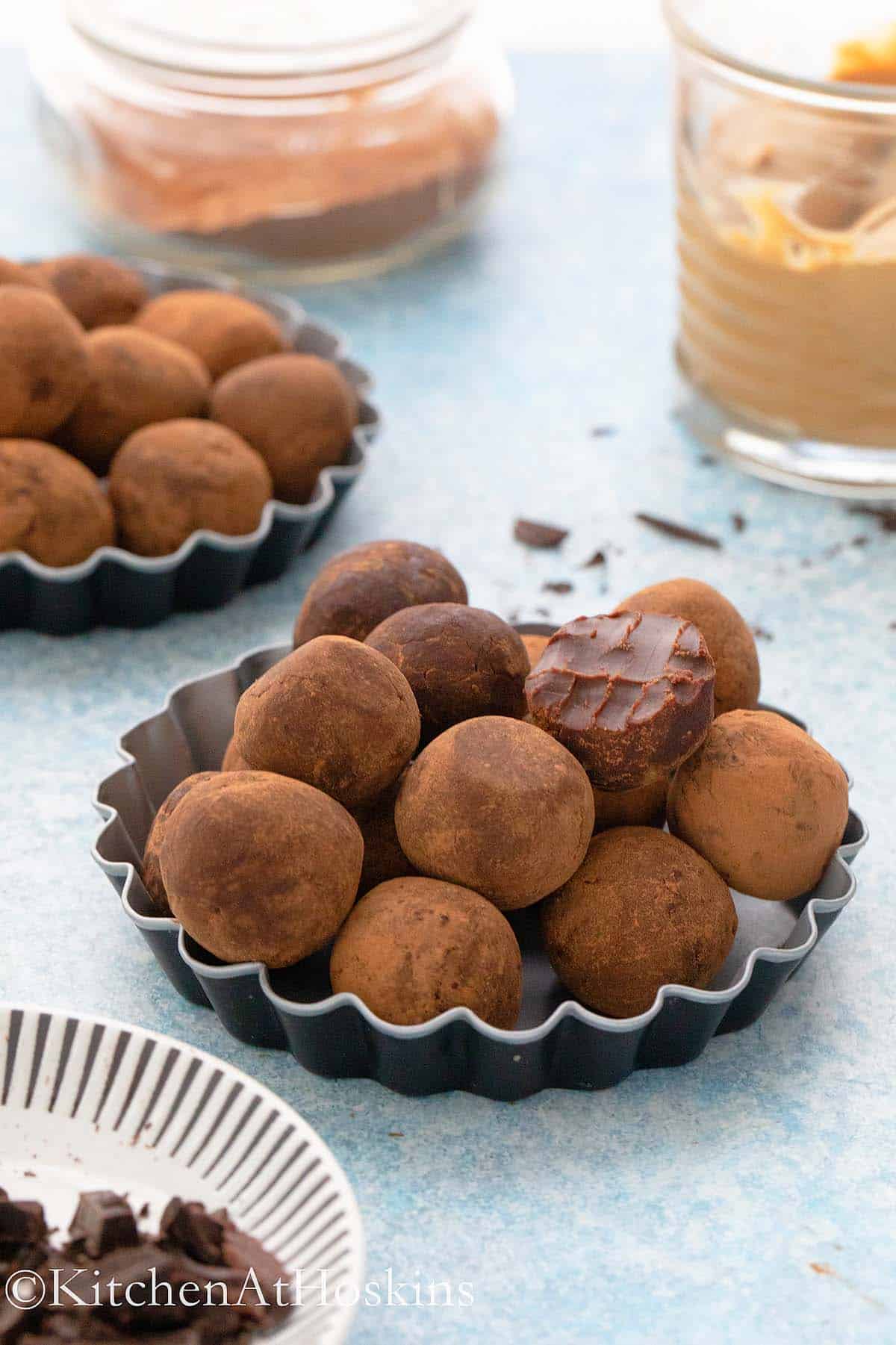 chocolate truffles made with almond butter in small tart pans.
