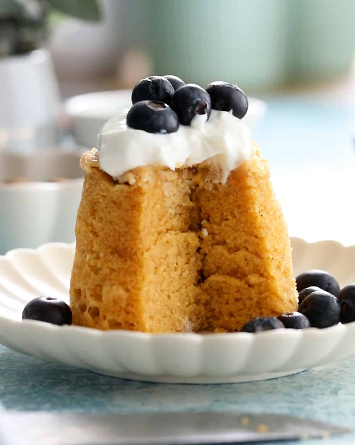 one yellow almond flour mug cake in a white plate.