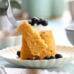 one yellow almond flour mug cake on a white plate.