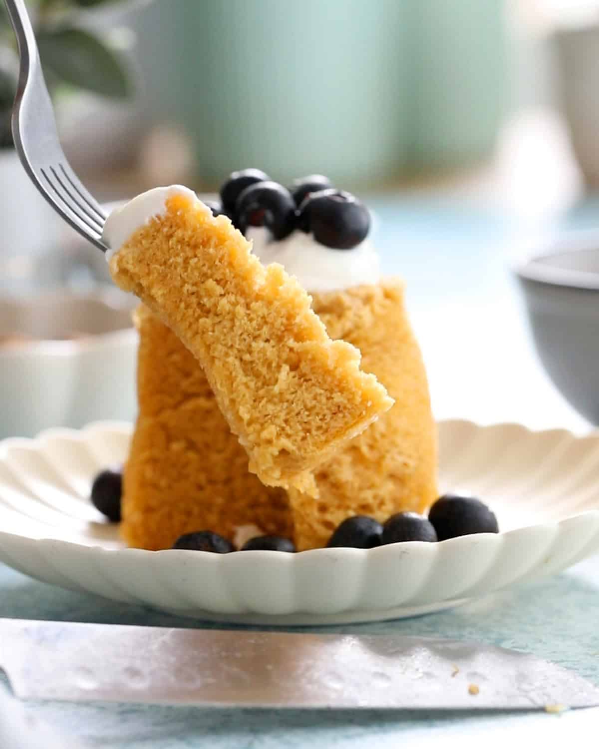 one yellow almond flour mug cake in a white plate.