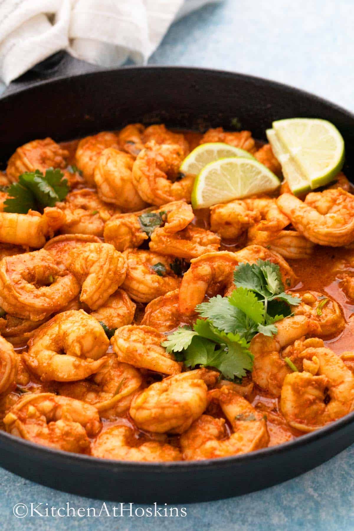cast iron skillet with spicy shrimp in chili lime sauce. 