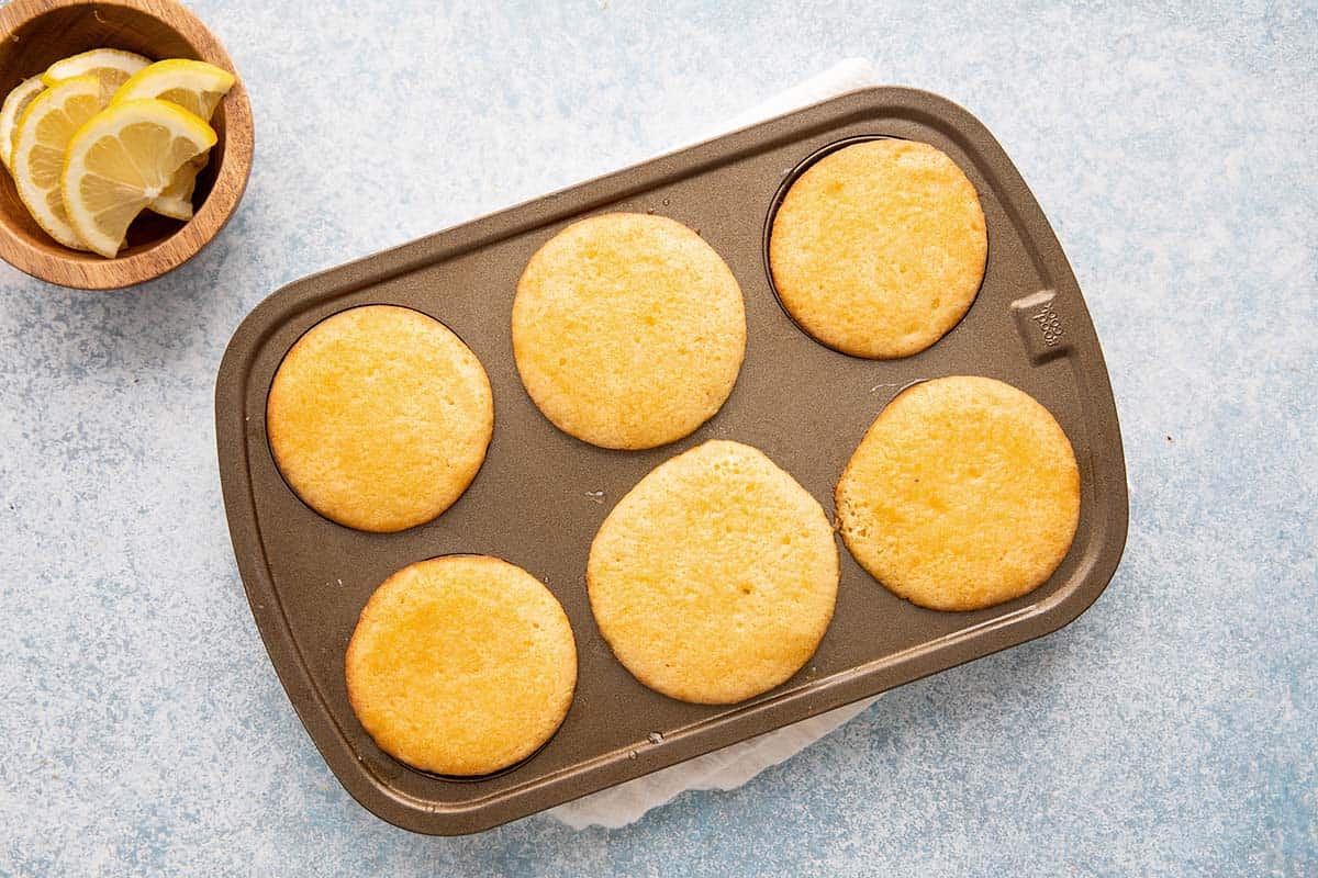 baked drizzle cupcakes in a muffin pan.