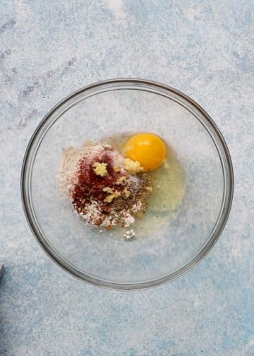 egg, flour and seasonings in a glass bowl.