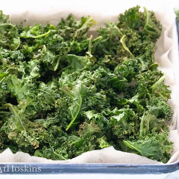 crispy kale chips in a white tray.