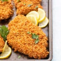 panko breaded chicken cutlets in a baking pan.