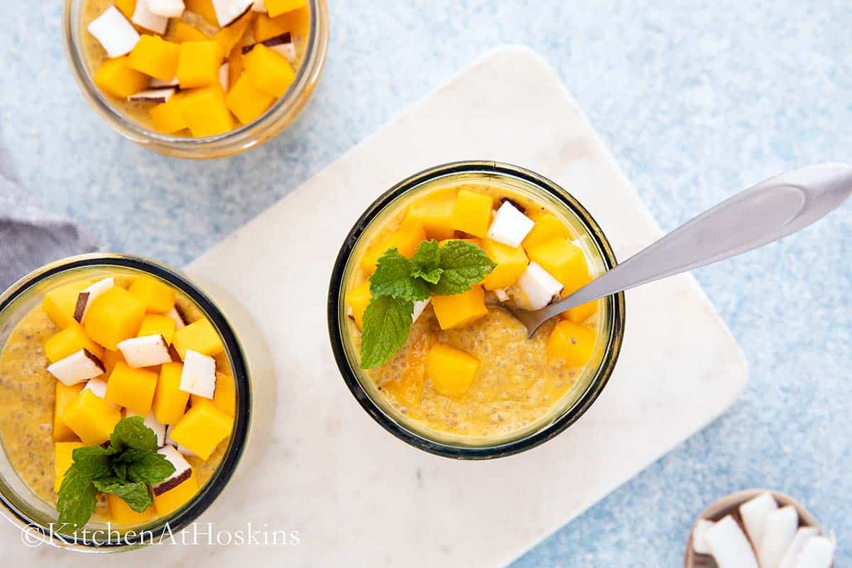 chia pudding with mango in glass jars.