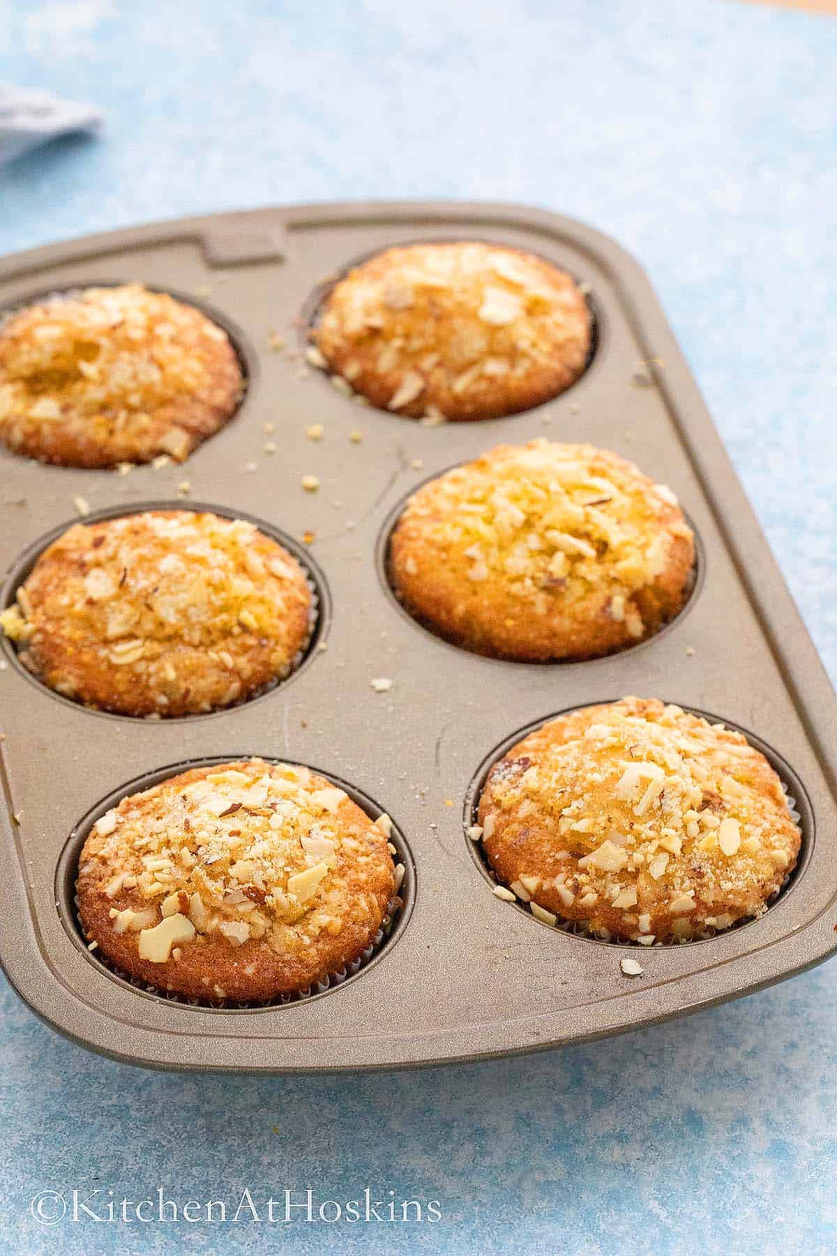 muffins made with orange juice in a muffin pan.