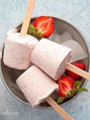 strawberry kulfi on a bowl filled with ice.
