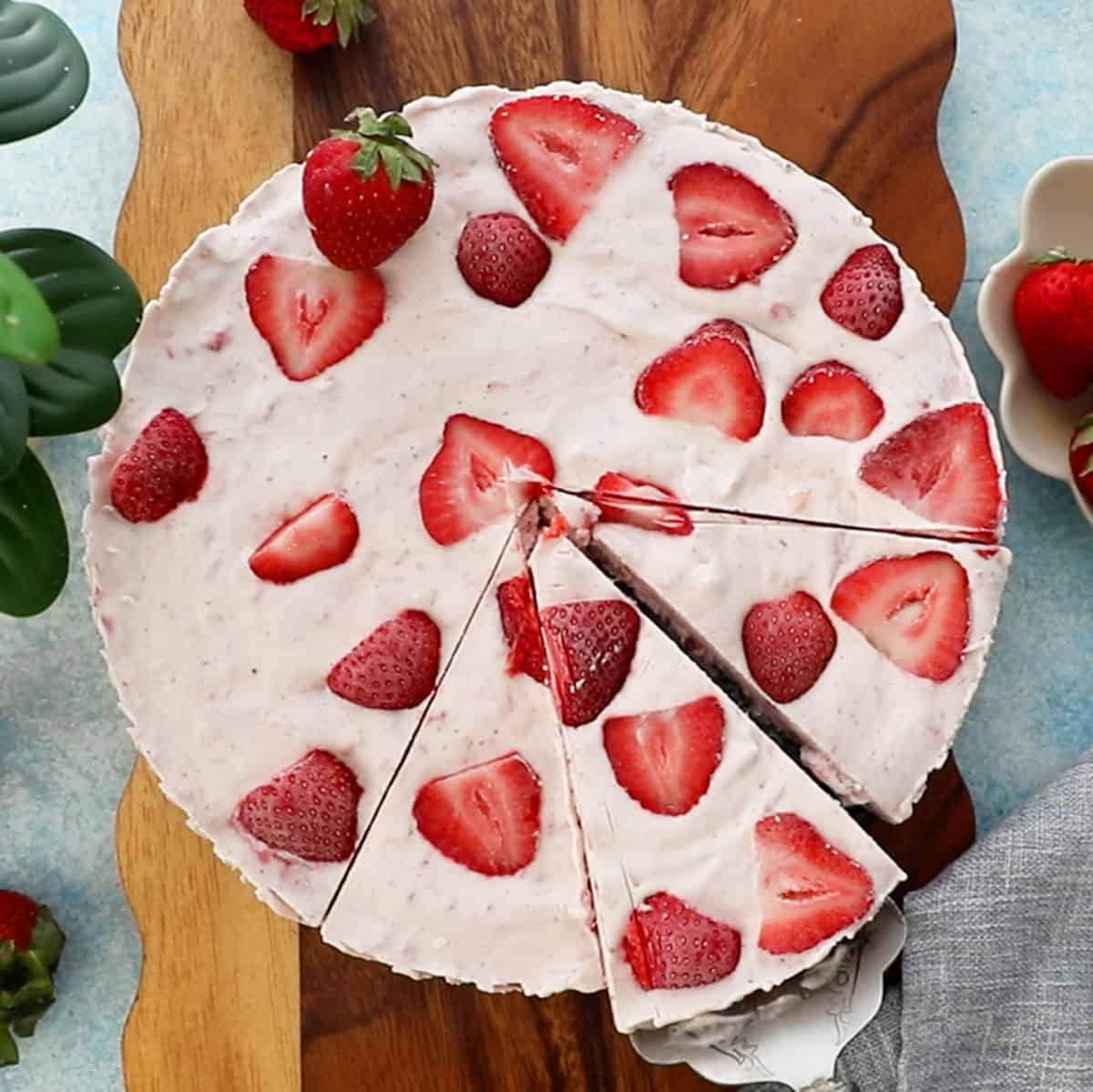 pink strawberry kulfi icecream on a brown board.