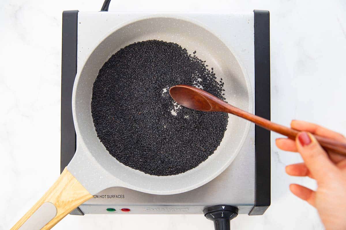 toasting black sesame seeds in a skillet.