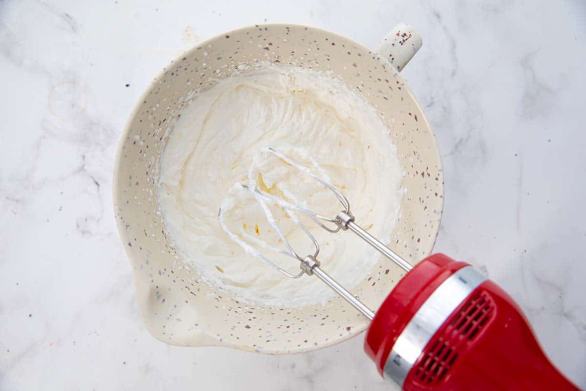whipped cream in a bowl along with the beater.