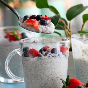 a spoonful of white coconut chia pudding above a glass jar.