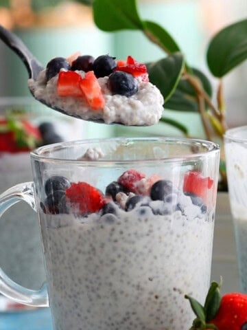 a spoonful of white coconut chia pudding above a glass jar.