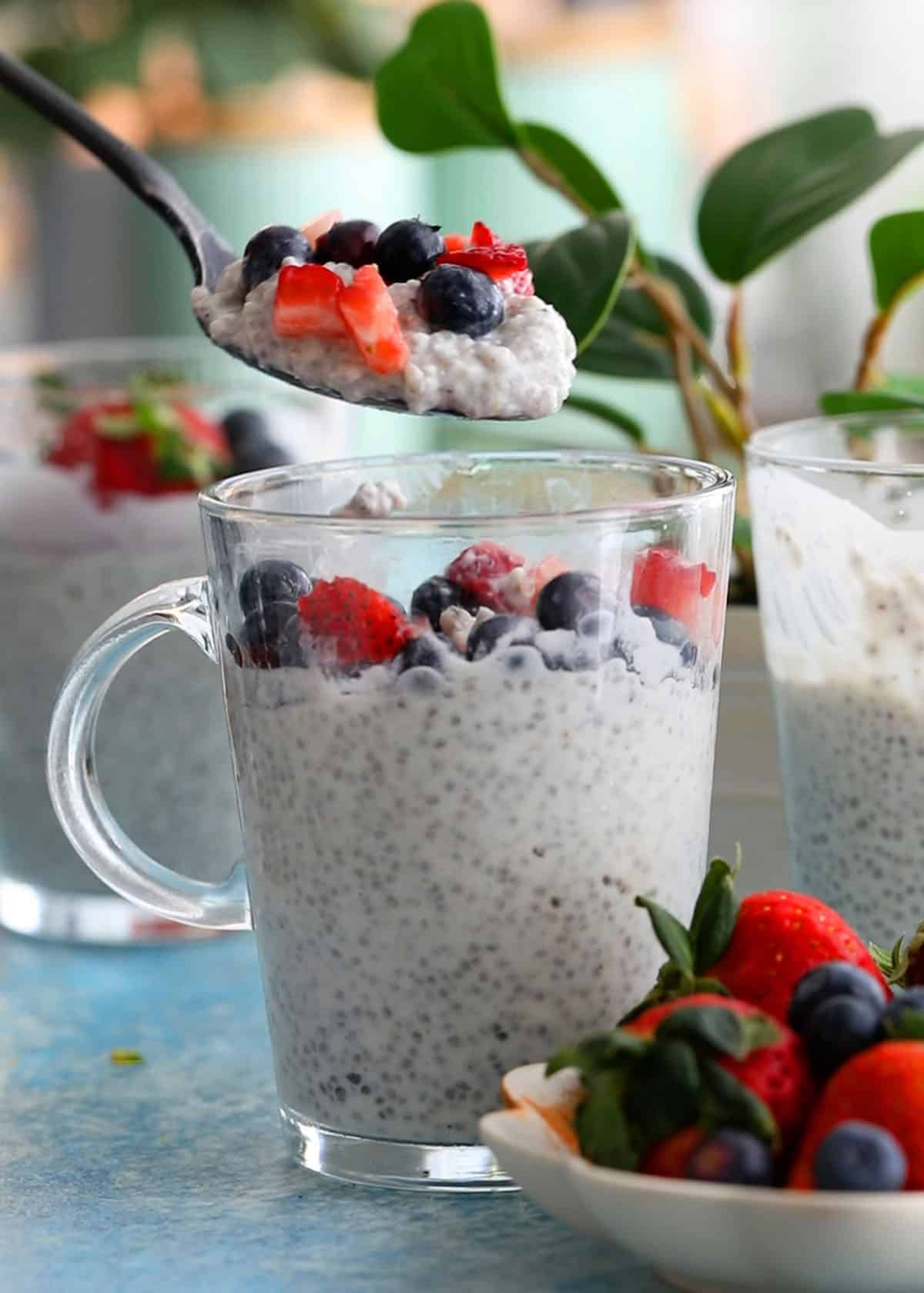 a spoonful of white coconut chia pudding above a glass jar.