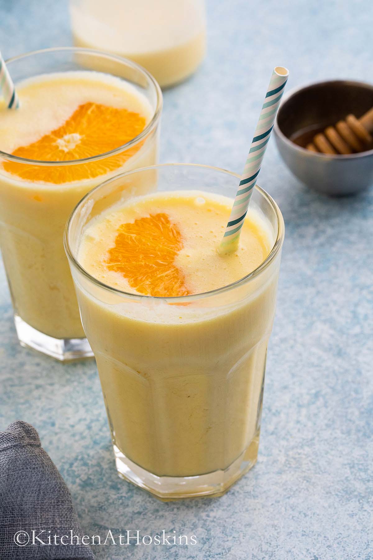 glasses filled with smoothie made with fresh oranges.
