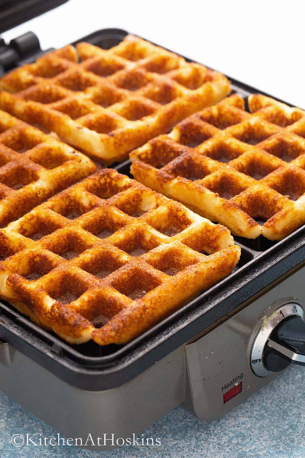 hot crisp waffles in a waffle maker. 