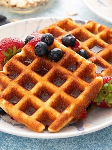 two square waffles placed on a white plate.