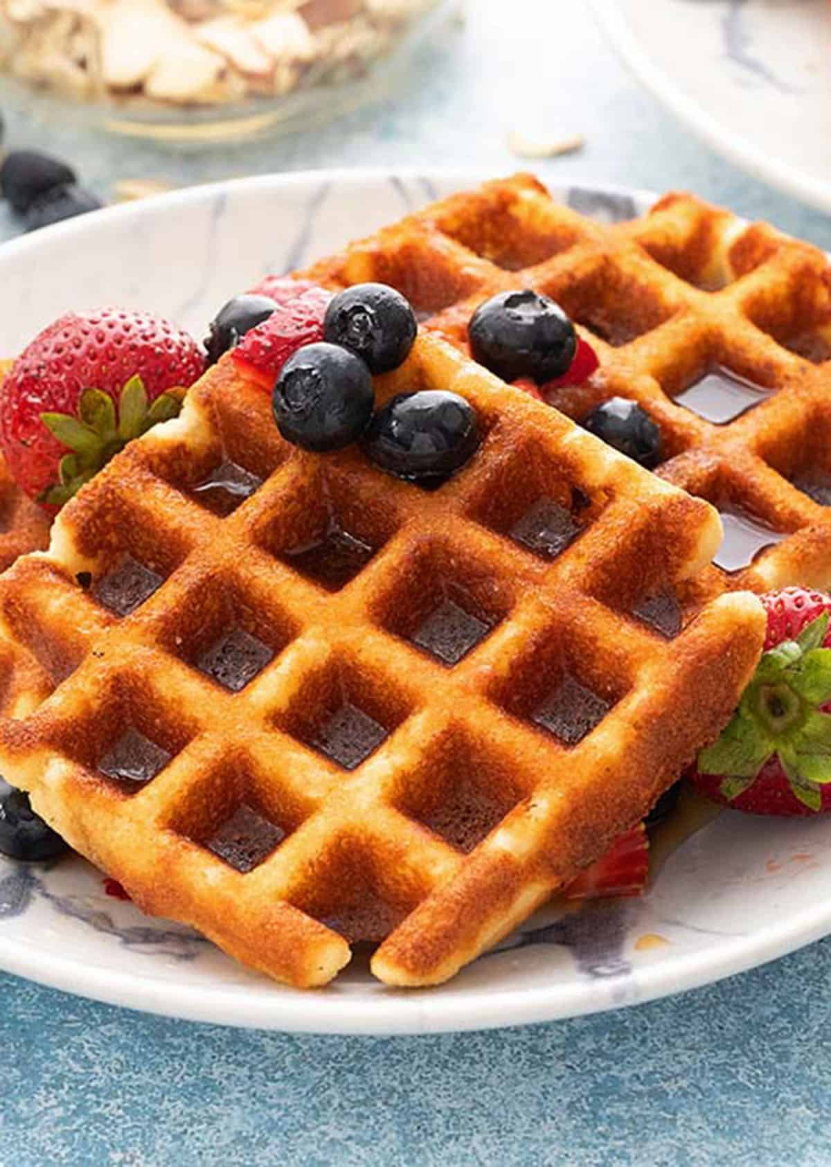 two square waffles placed on a white plate.