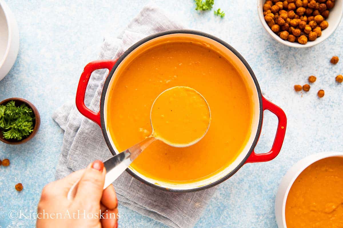 a ladle filled with blended chickpeas soup. 