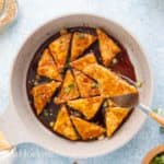 a pan with fried tofu in teriyaki sauce.