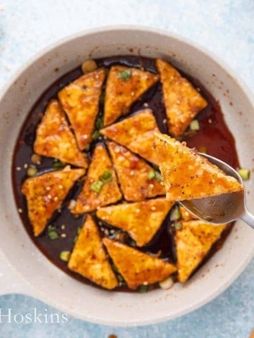 a pan with fried tofu in teriyaki sauce.