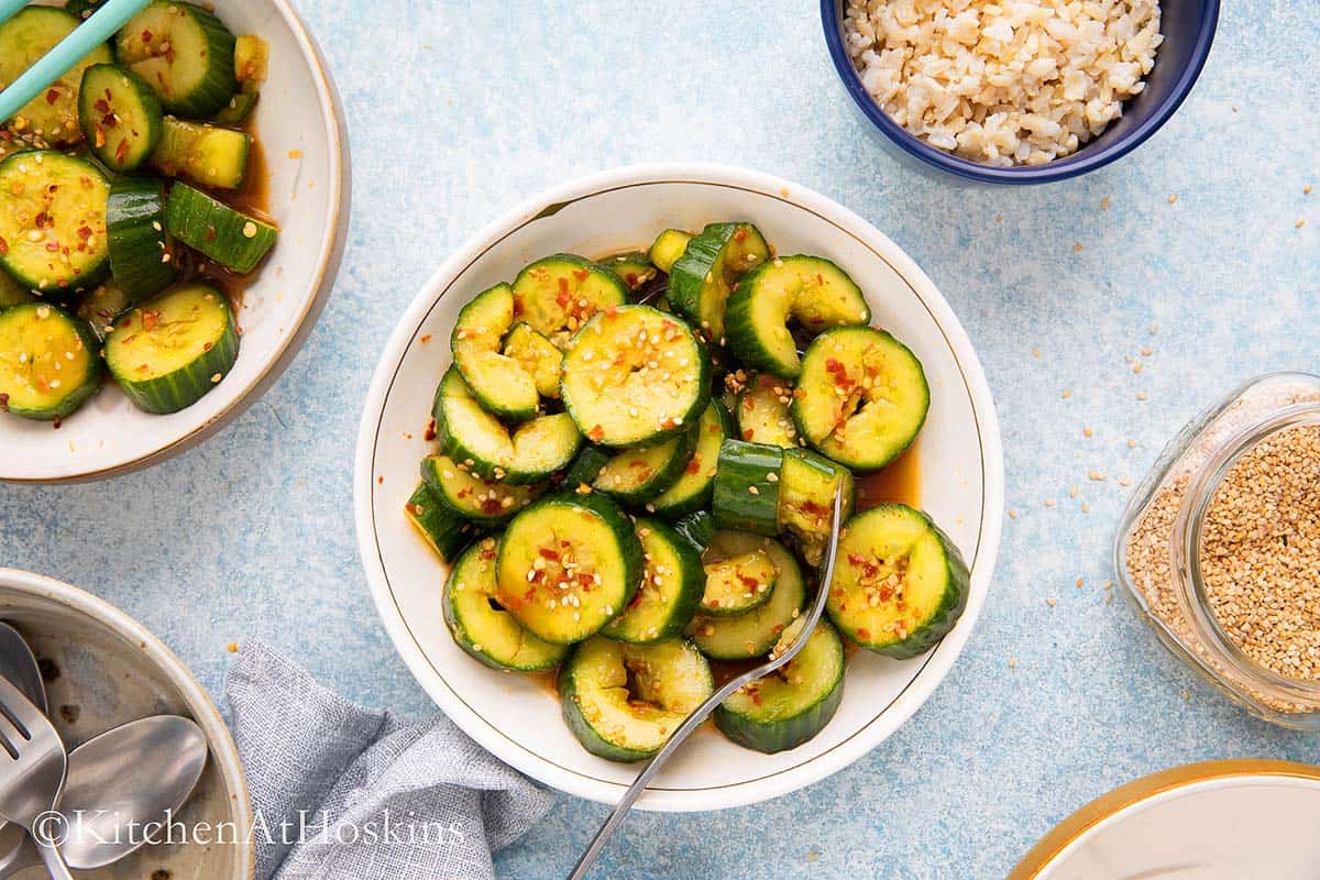bowls with Asian cucumber salad with  forks.
