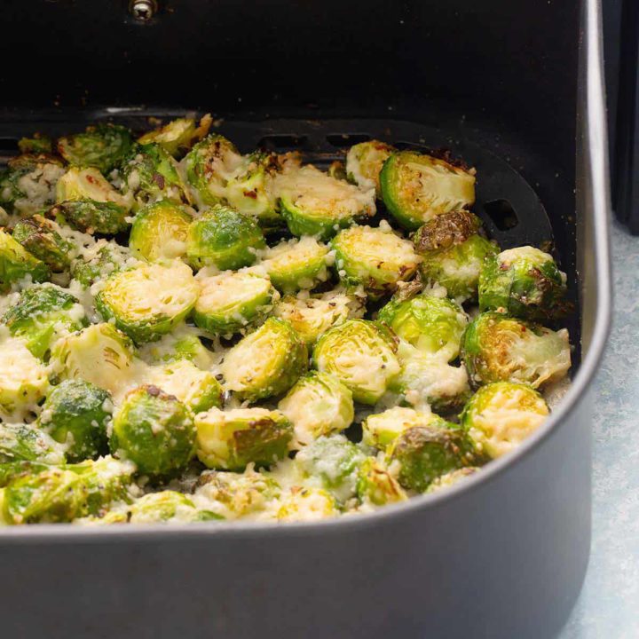 air fryer basket with parmesan crusted brussels sprouts.