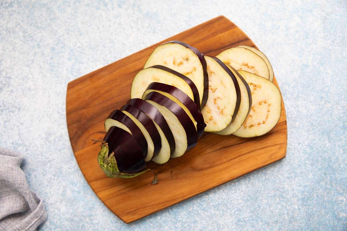 sliced eggplant on a wooden board.