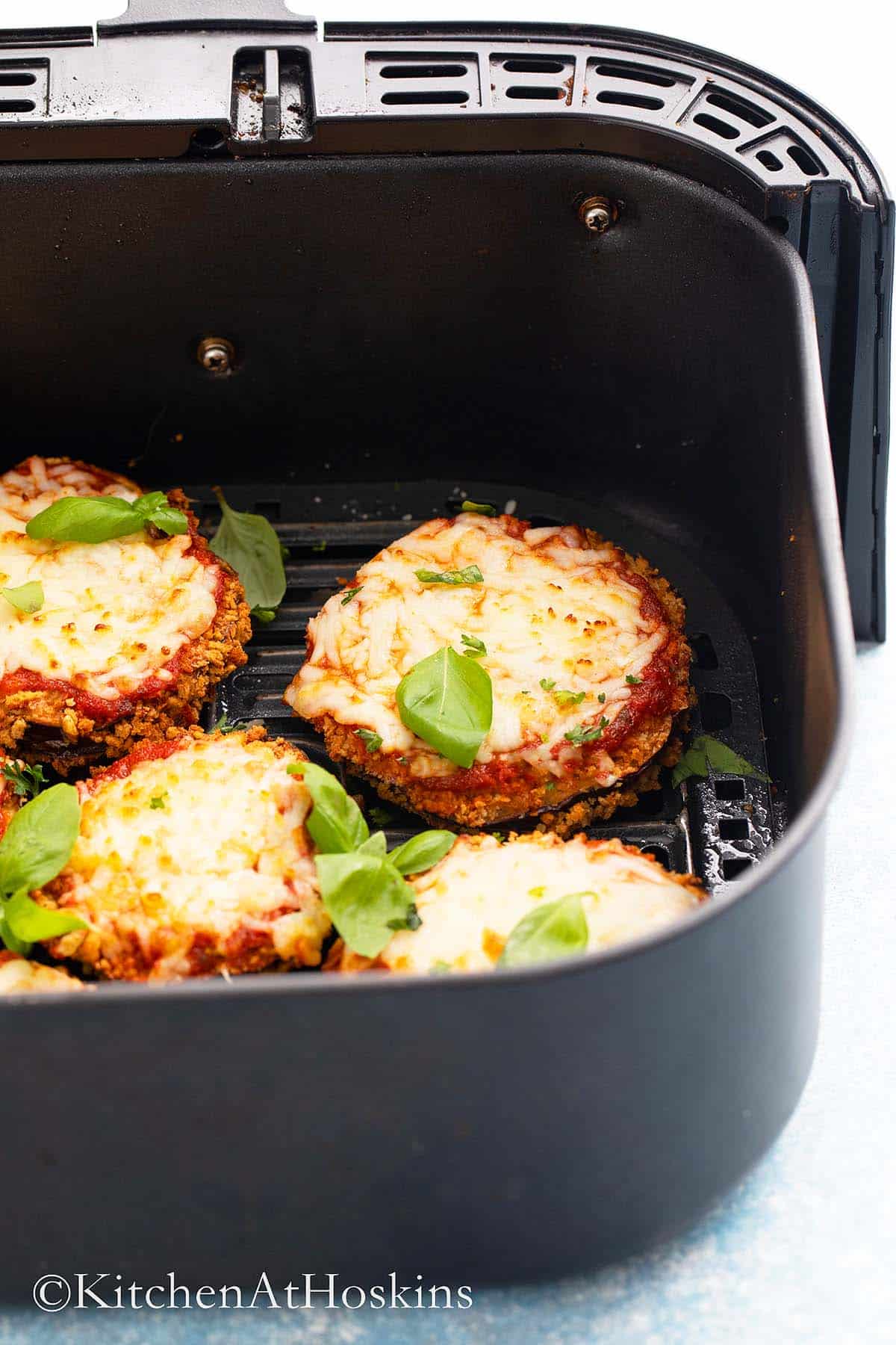 eggplant parmesan in air fryer basket.