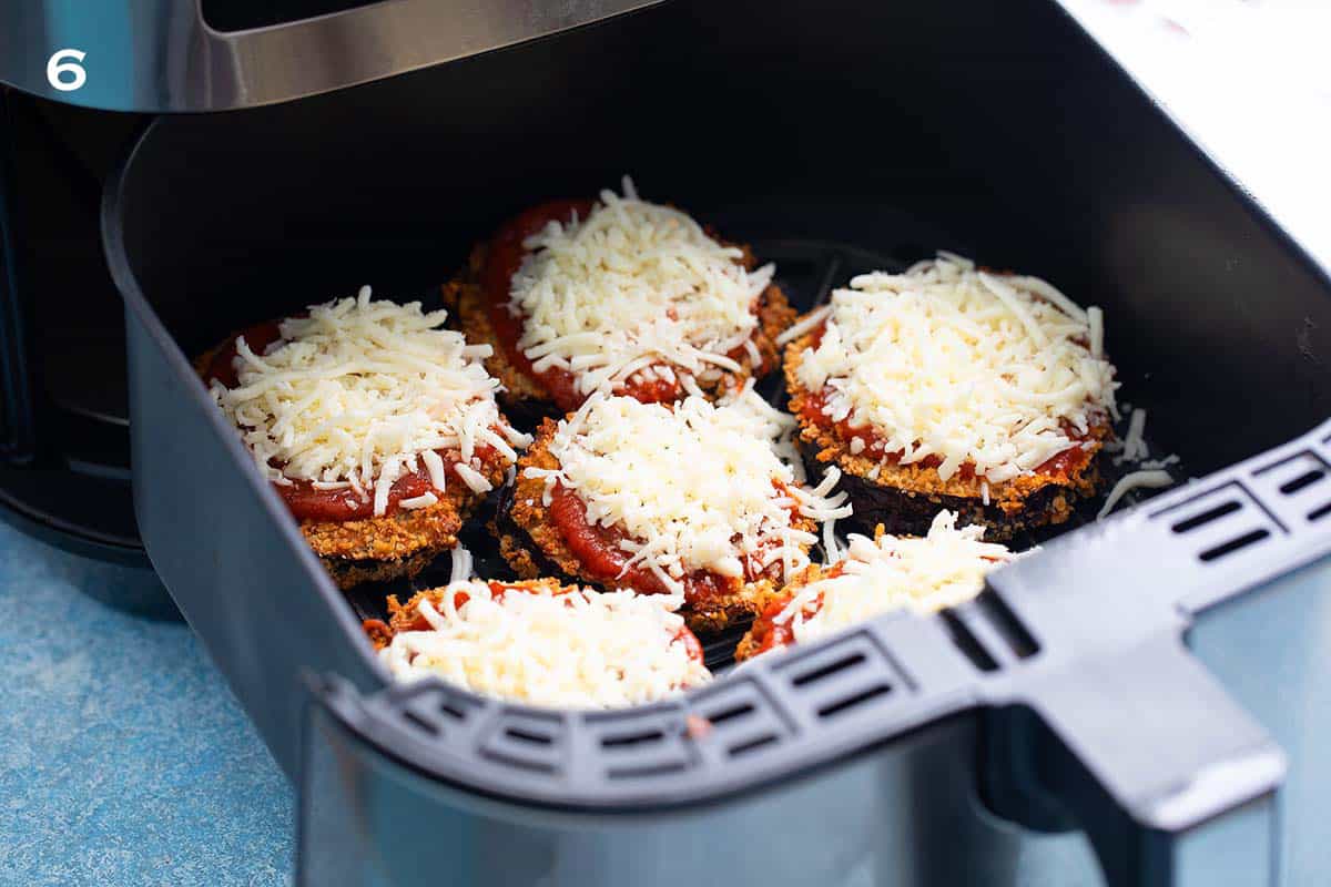 6 cooked eggplant slices topped with tomato sauce and shredded mozzarella.