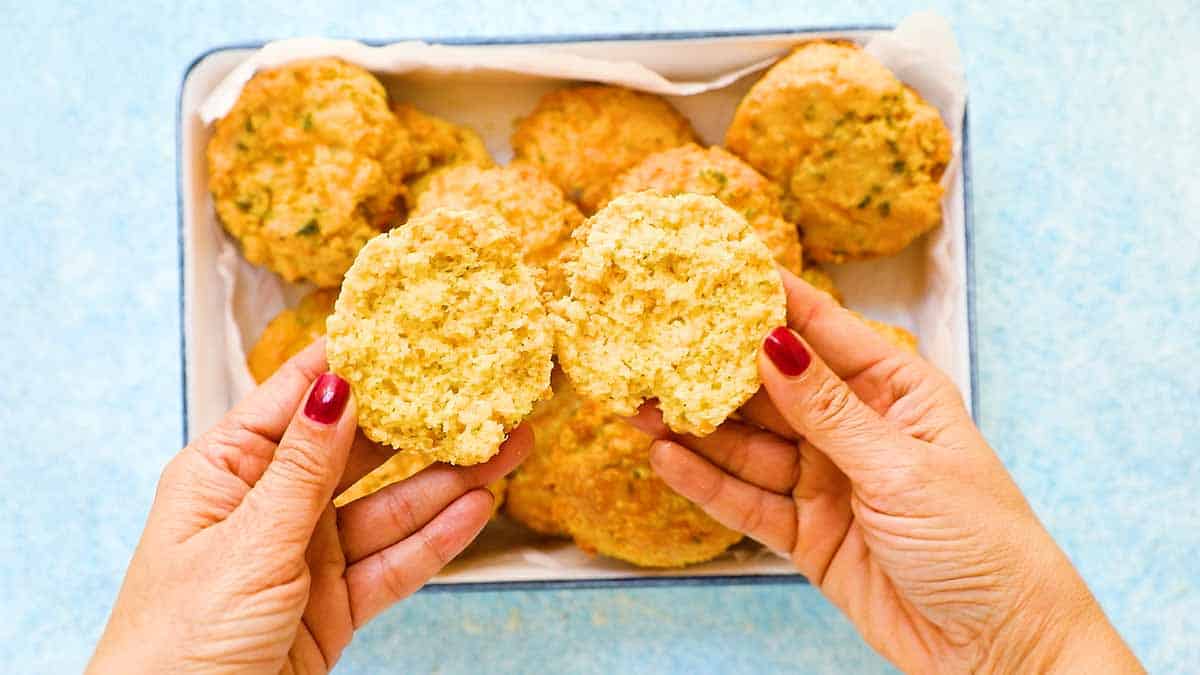 two hands holding a split open biscuit.