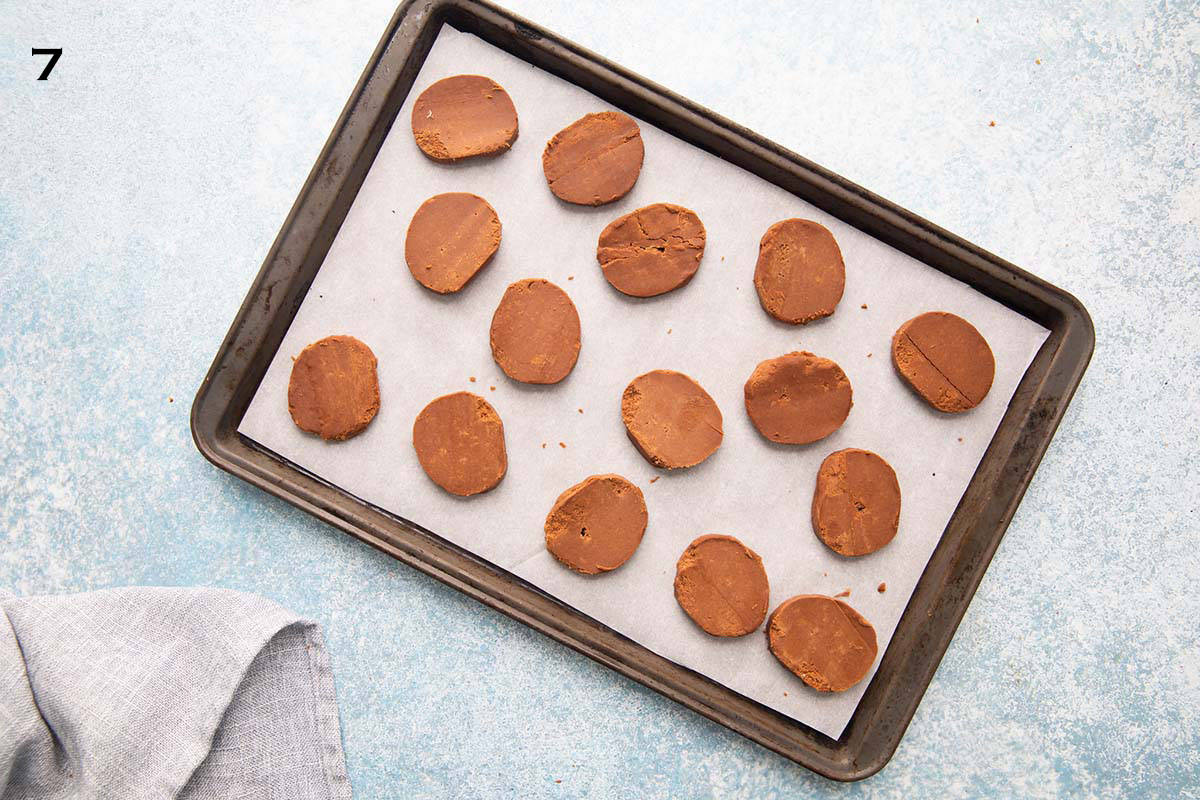 sliced chocolate cookie dough placed on a parchment lined baking sheet.