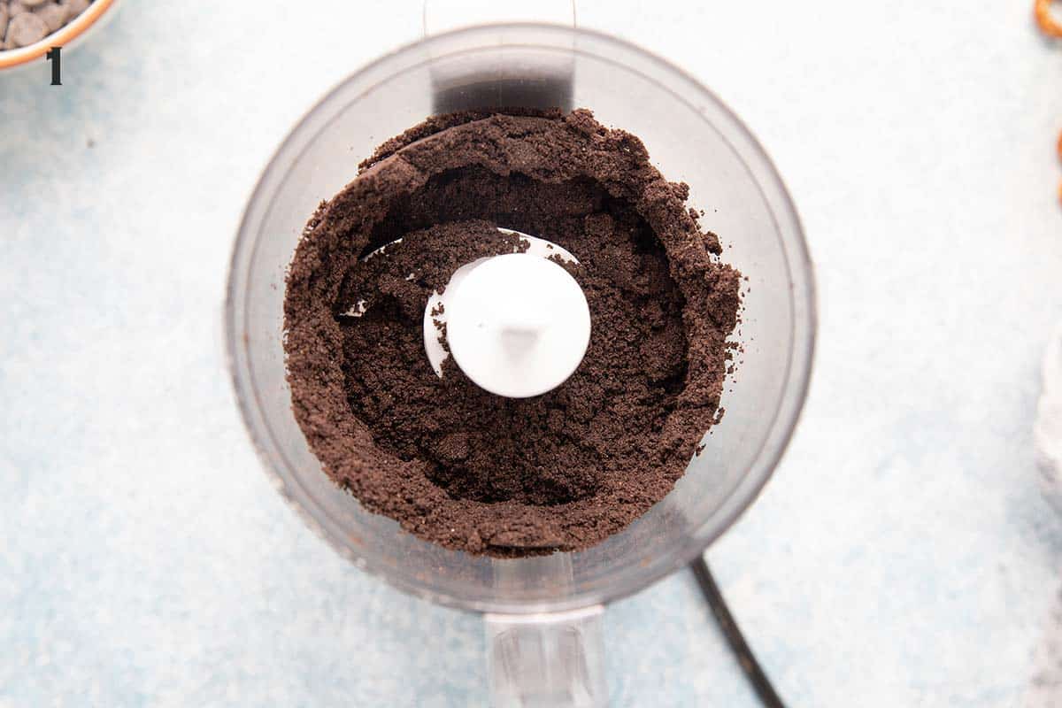 a food processor with crushed oreos.