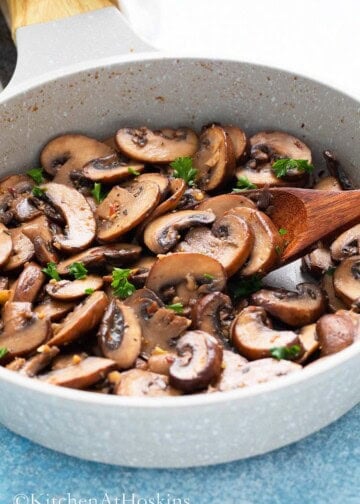 cooked sliced mushrooms in a small white skillet.