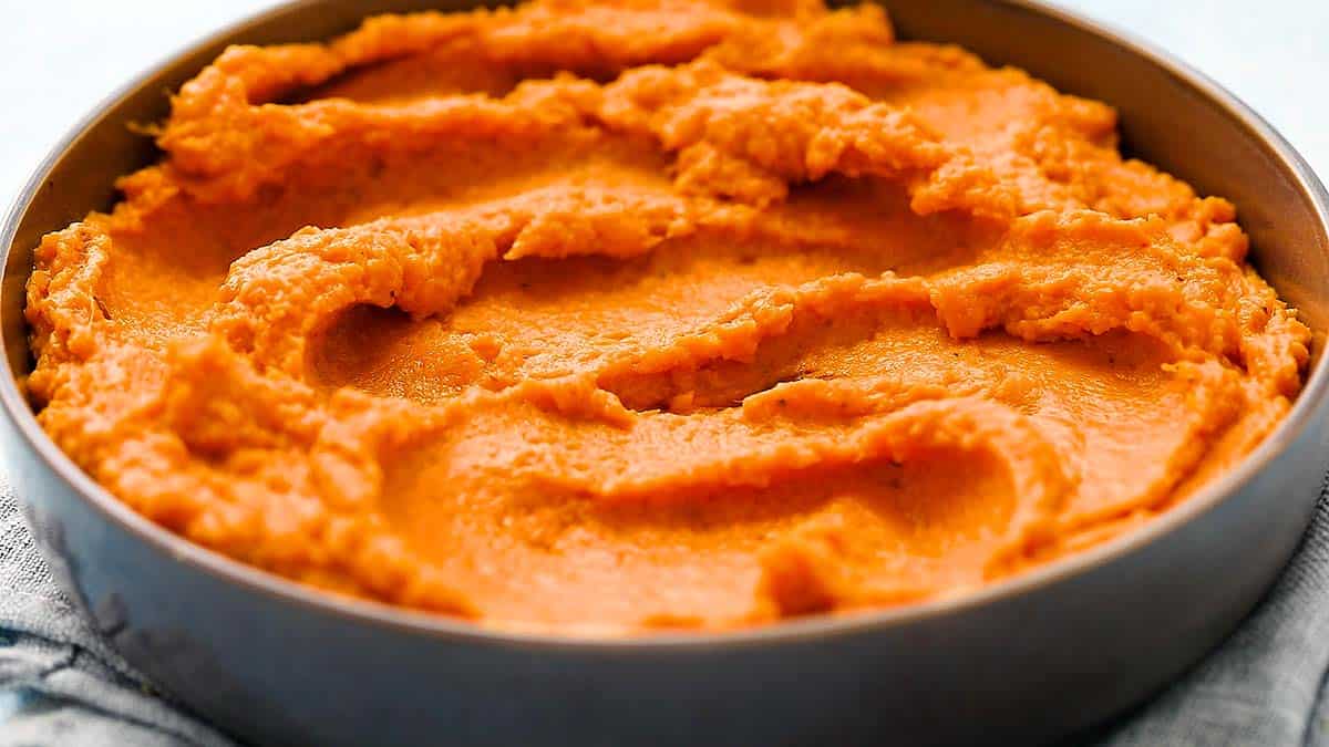 a grey dish with mashed sweet potatoes. 