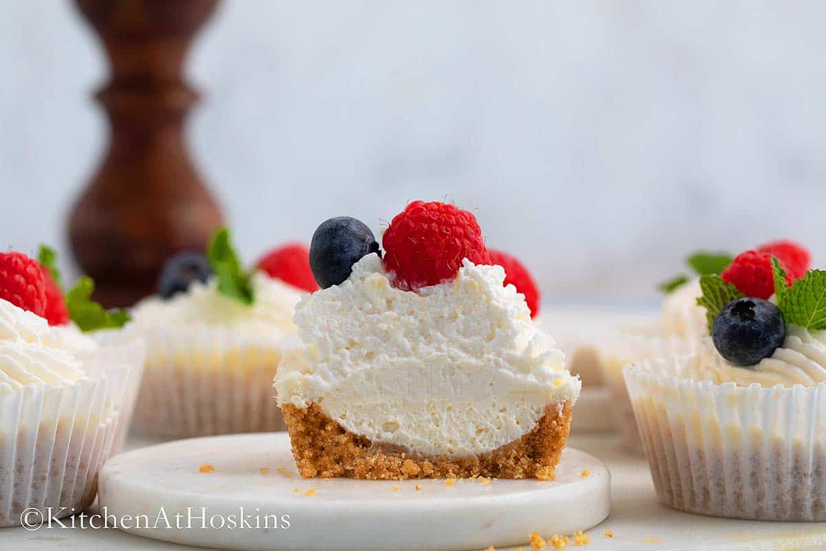 half cut mini cheesecake on a round board.