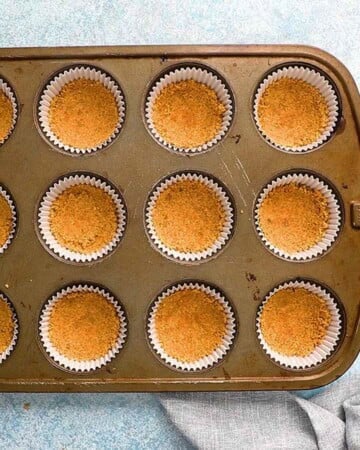 one muffin pan lined with graham cracker crust.